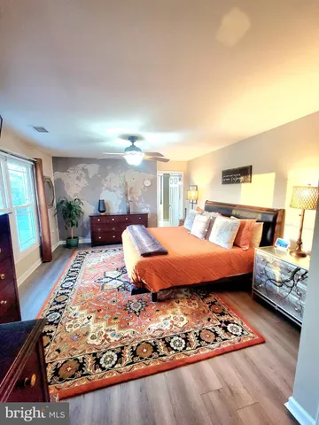 a bedroom with furniture and a rug