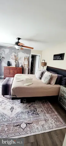 a bedroom with a bed and a night stand