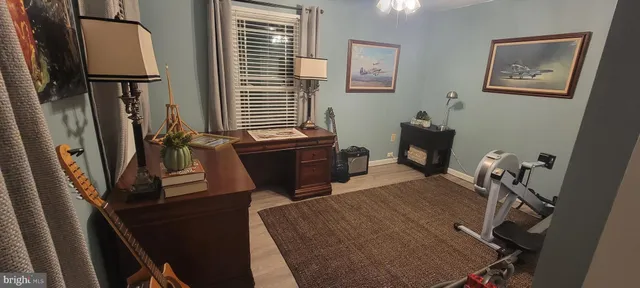 a view of a workspace with furniture and a window