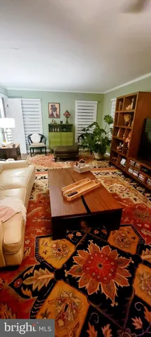 a view of a room with furniture and wooden floor