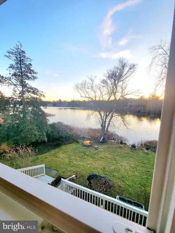 a view of a green field with wooden fence
