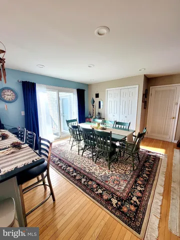 a living room with a rug a dining table and window