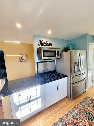 a kitchen with granite countertop a refrigerator and a stove
