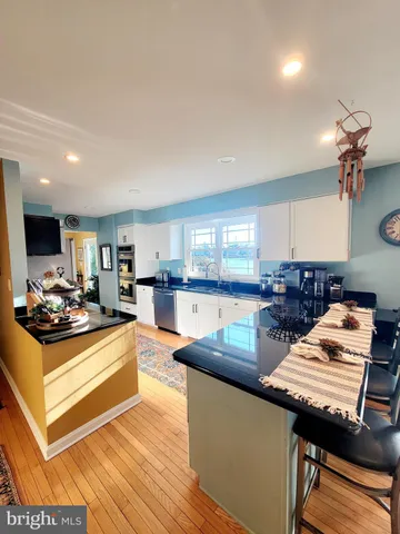 a kitchen with stainless steel appliances granite countertop a stove and a view of kitchen