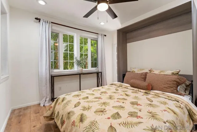 a bedroom with a bed and a television