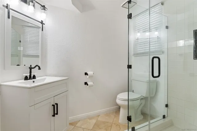 a view of a balcony with floor to ceiling windows and wooden fence