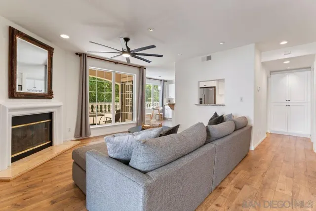 a living room with furniture and kitchen view