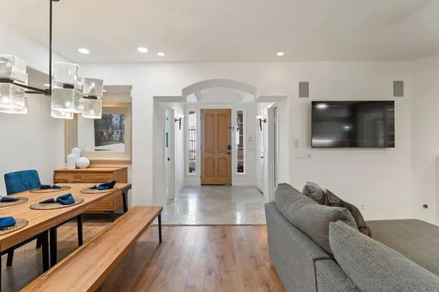 a kitchen with granite countertop a sink window and cabinets