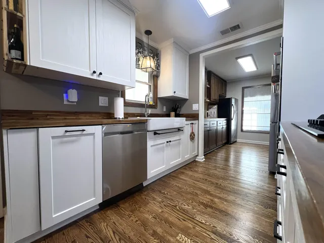 a kitchen with stainless steel appliances granite countertop a stove sink and cabinets