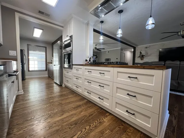 a view of swimming pool with trees and wooden fence