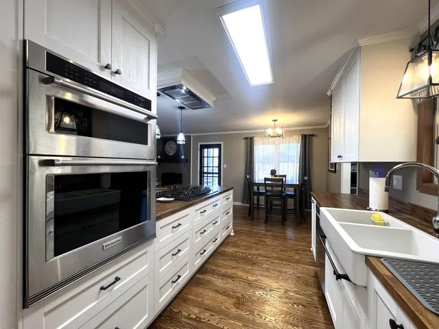 a kitchen with stainless steel appliances kitchen island granite countertop a refrigerator and a stove