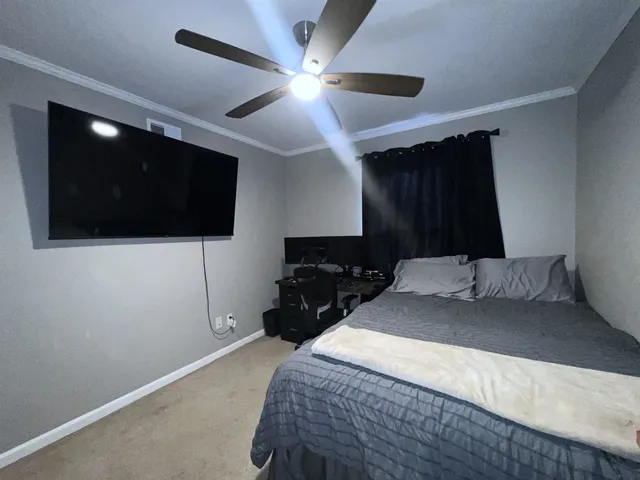 a bedroom with a bed and a desk