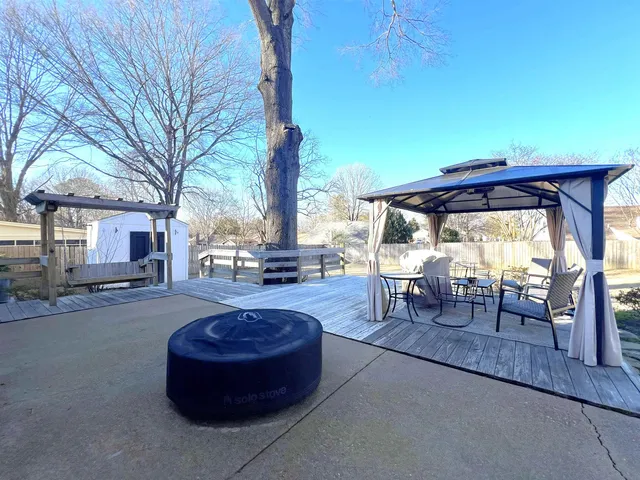 a bed room with a bed a television and a dresser