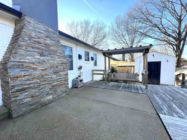a view of a patio with a table chairs and a fire pit