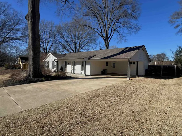 a view of a house with a yard and garage