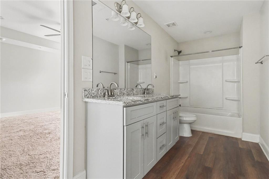 3352 Mt Zion Road Stockbridge, GA 30281 - Photo 11 of 22 a bathroom with a granite countertop sink mirror vanity and toilet