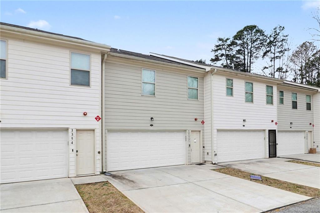 3352 Mt Zion Road Stockbridge, GA 30281 - Photo 22 of 22 a view of a house with a backyard and garage