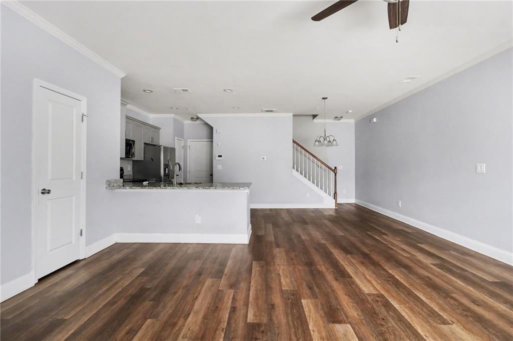 3352 Mt Zion Road Stockbridge, GA 30281 - Photo 8 of 22 a view of a room with wooden floor and a ceiling fan