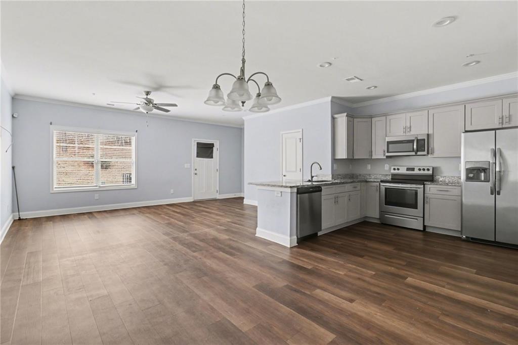 3352 Mt Zion Road Stockbridge, GA 30281 - Photo 9 of 22 a view of kitchen with stainless steel appliances granite countertop a stove a sink dishwasher and a refrigerator with wooden floor