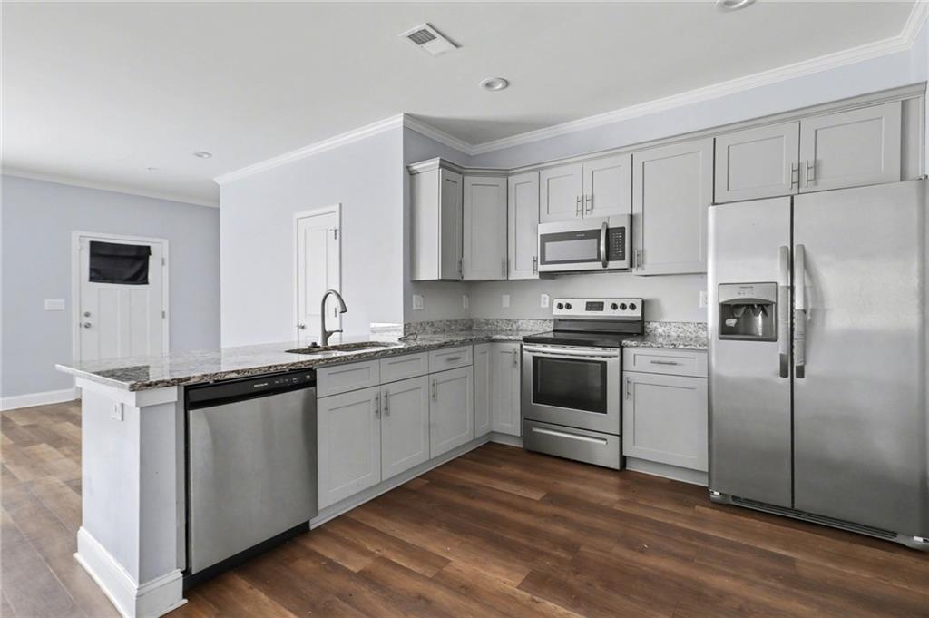 3352 Mt Zion Road Stockbridge, GA 30281 - Photo 10 of 22 a kitchen with granite countertop a refrigerator stove top oven and sink