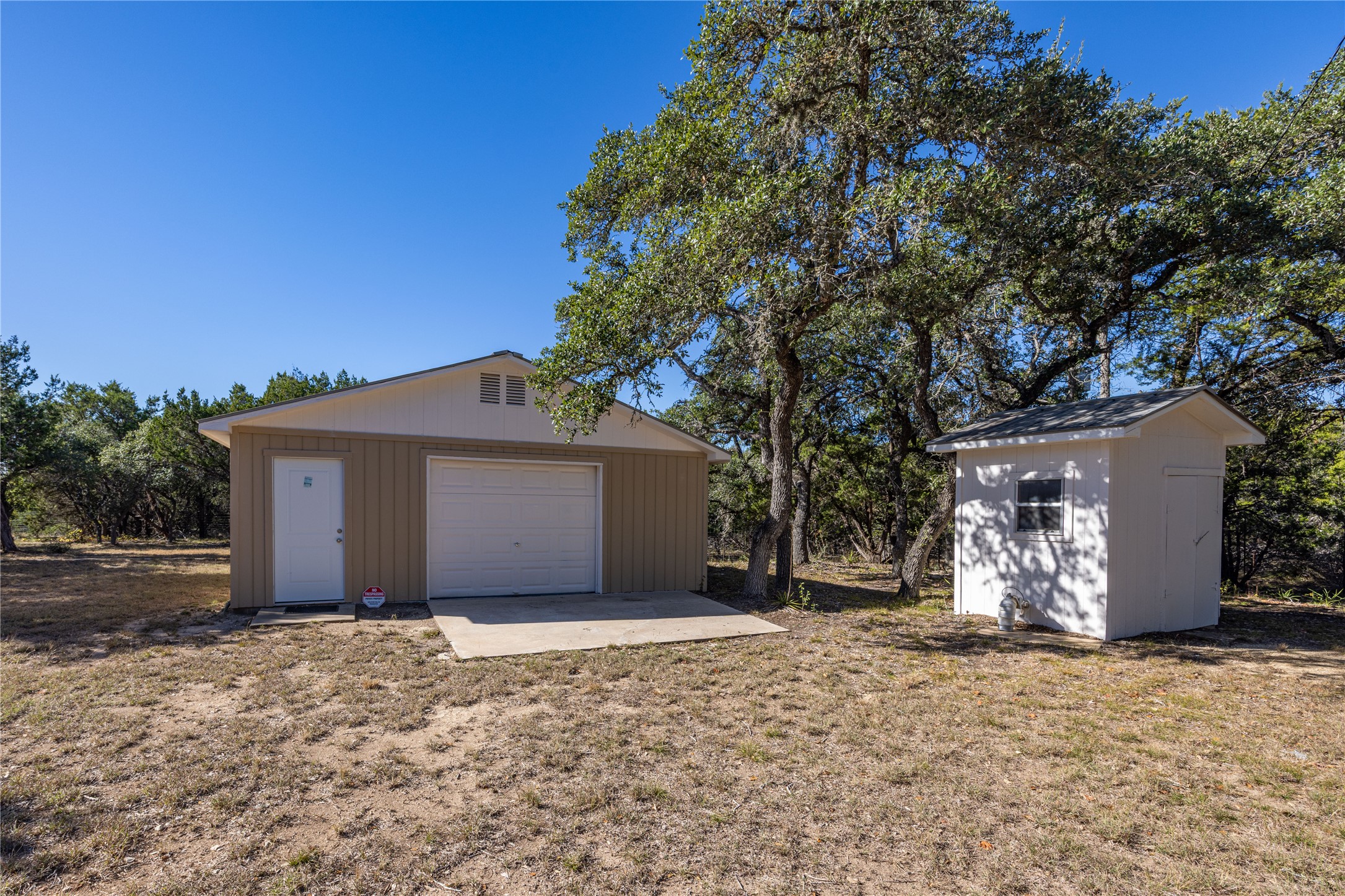 2501 Fischer Store Road Wimberley, TX 78676 - Photo 19 of 23 Detached metal-sided garage with a single vehicle door and pedestrian access