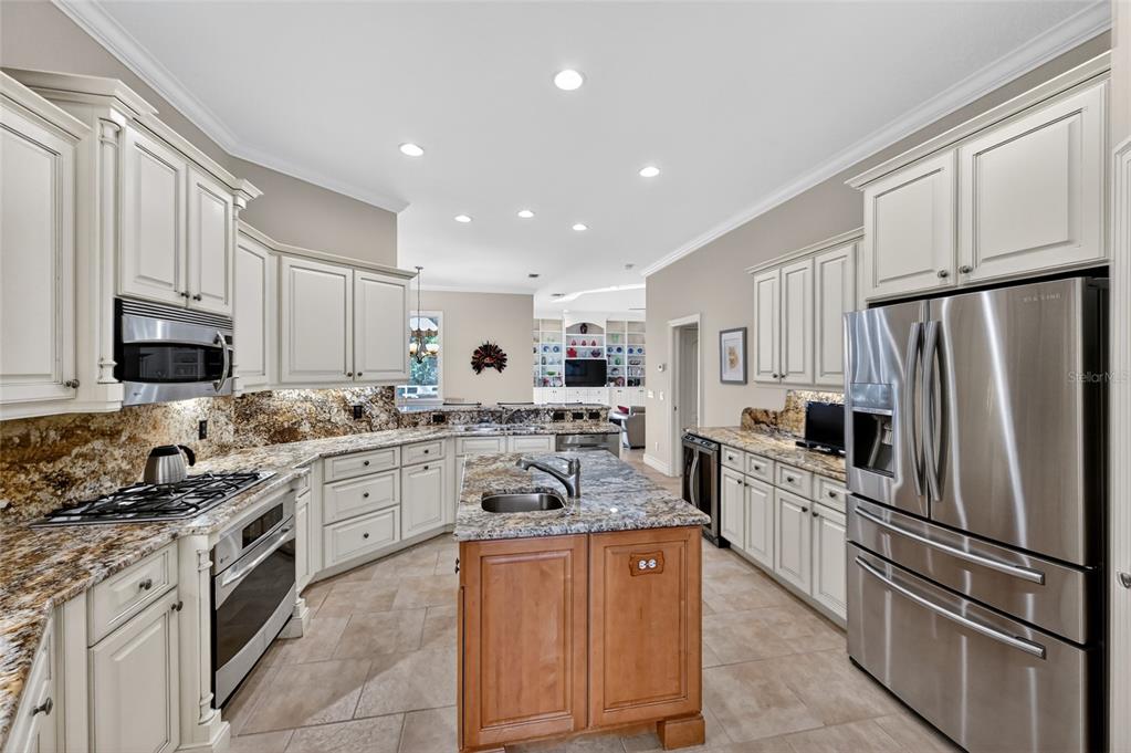 404 Partridge Circle Sarasota, FL 34236 - Photo 13 of 33 a kitchen with granite countertop stainless steel appliances and cabinets