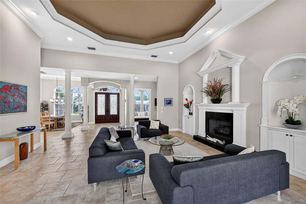 404 Partridge Circle Sarasota, FL 34236 - Photo 5 of 33 a living room with furniture a fireplace and a flat screen tv