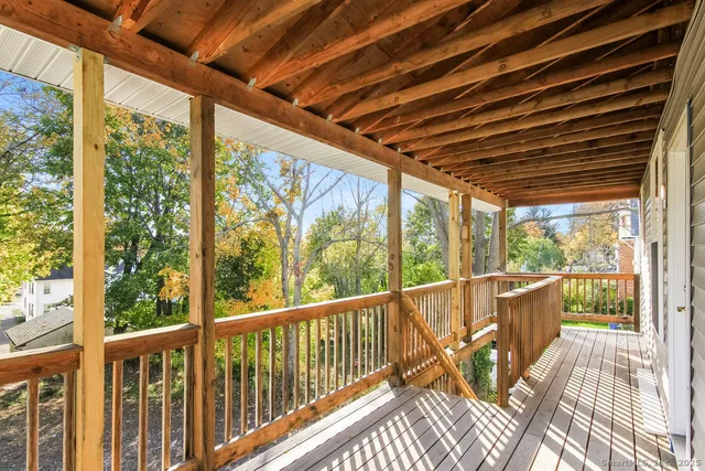 a view of a balcony with wooden floor