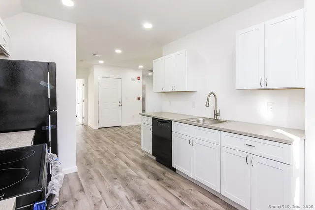 a kitchen with a sink stainless steel appliances and cabinets