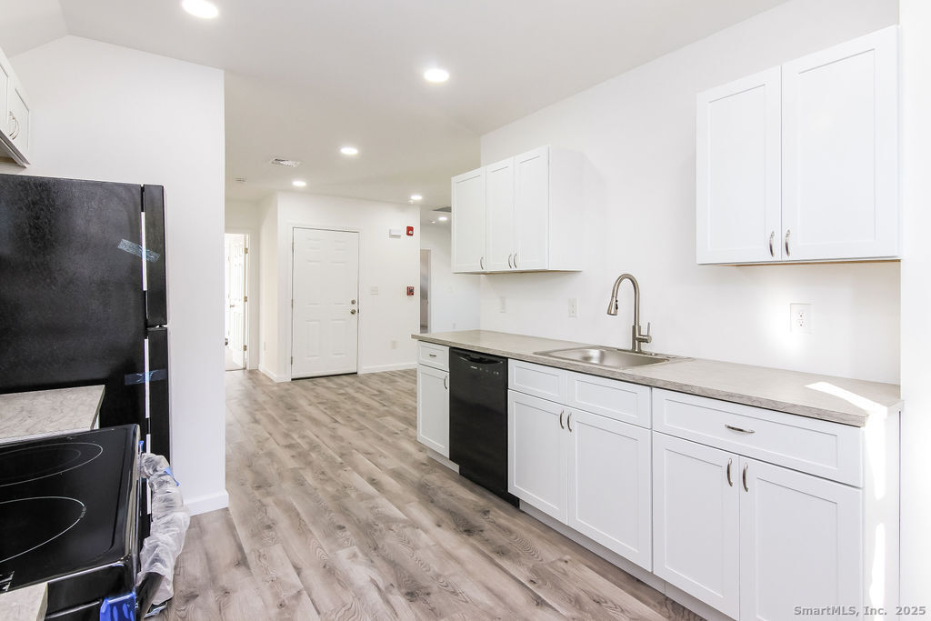 66 Winthrop Street, Unit 3 New Britain, CT 06052 - Photo 4 of 7 a kitchen with a sink stainless steel appliances and cabinets