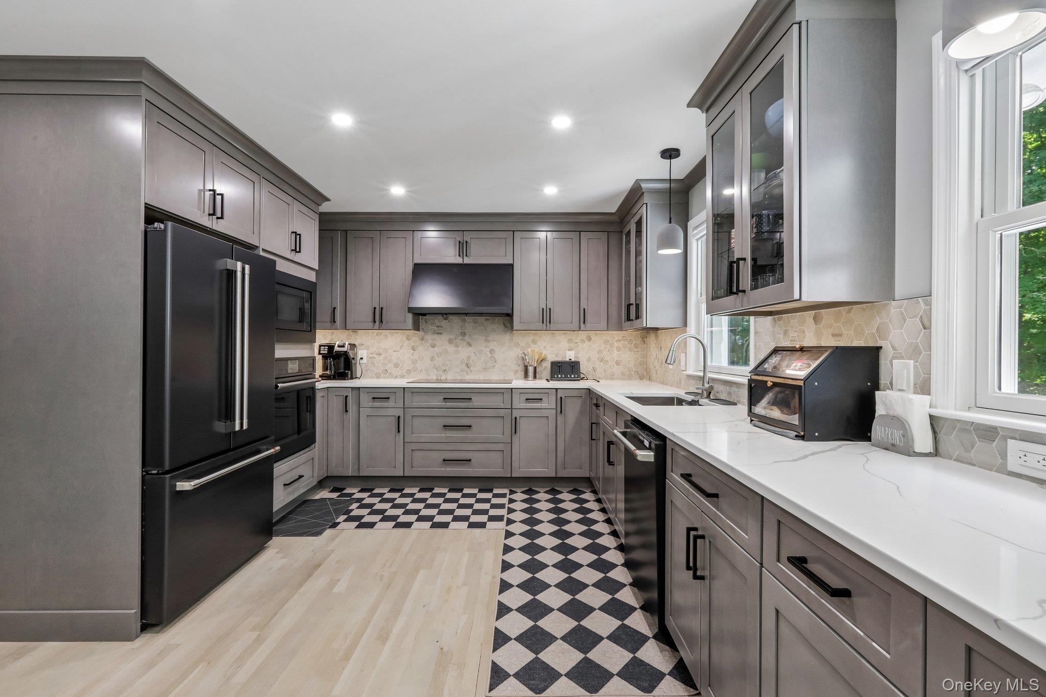 62 Mohegan Road Larchmont, NY 10538 - Photo 24 of 46 a kitchen with a refrigerator sink and cabinets
