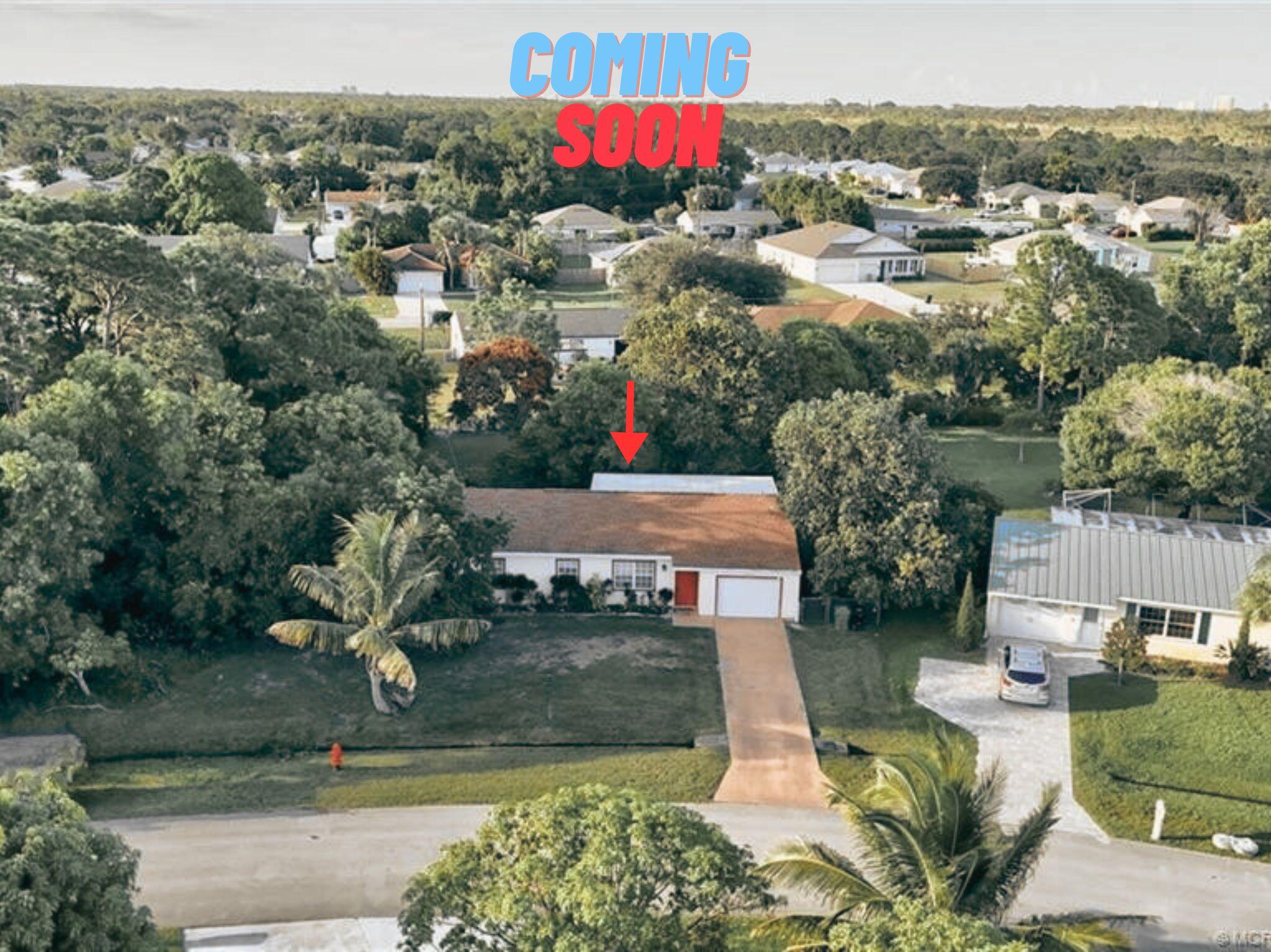 2431 Southeast Robin Circle Port St. Lucie, FL 34952 - Photo 1 of 1 an aerial view of a house with yard