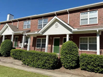 front view of a brick house with a large window
