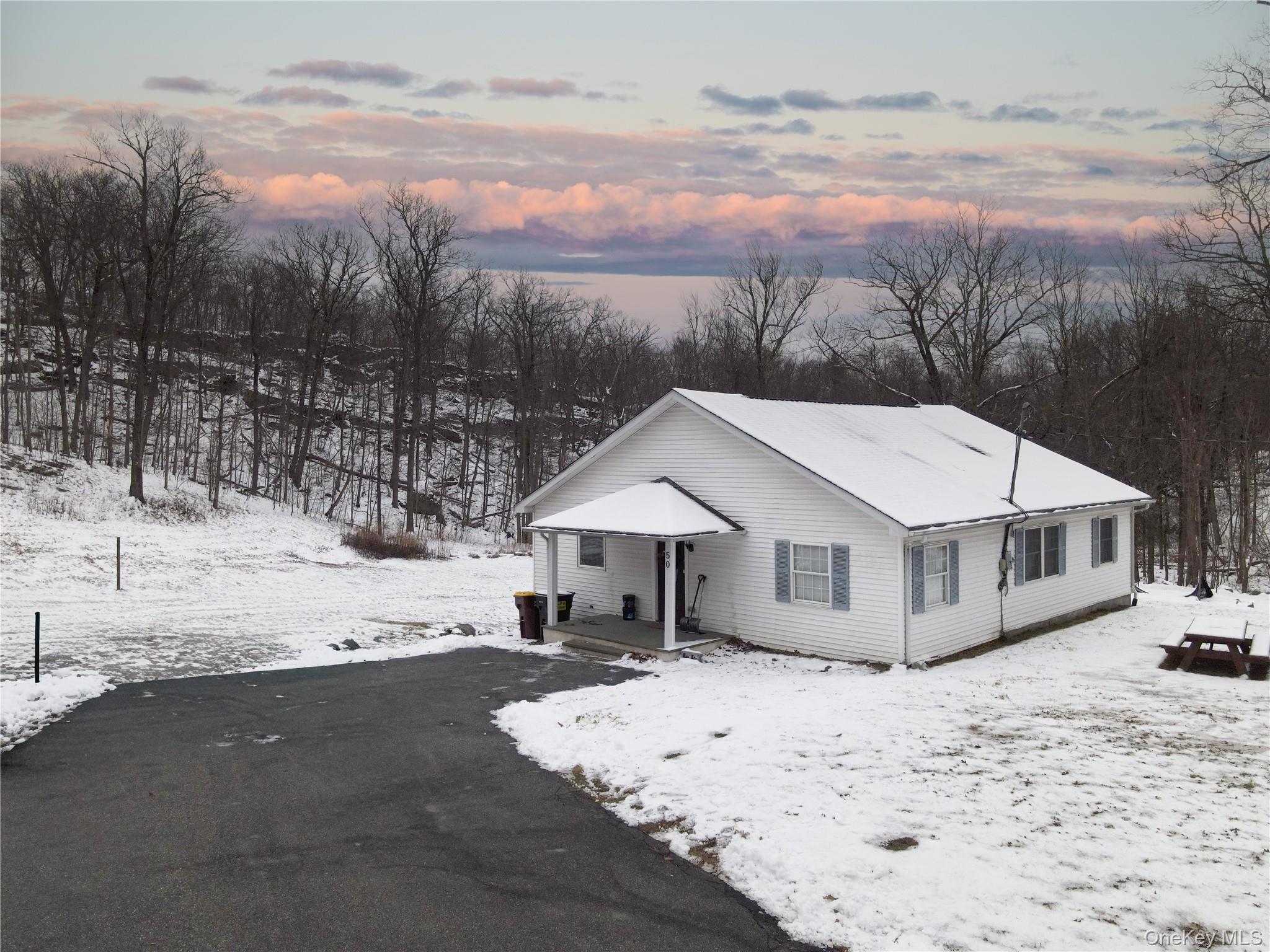 50 Continental Road Warwick, NY 10990 - Photo 22 of 46 a view of a house with a yard covered in snow