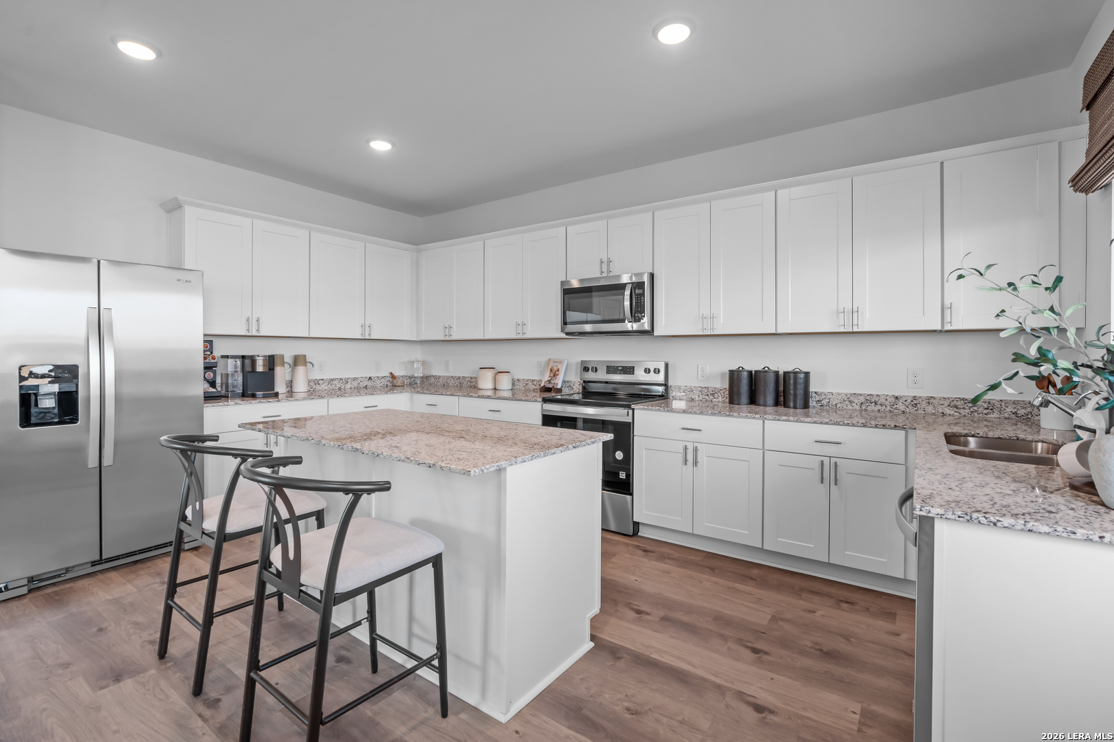 424 Raven Row Marion, TX 78124 - Photo 11 of 30 a kitchen with a refrigerator a stove top oven a sink and cabinets