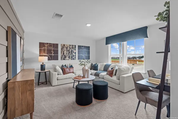 a living room with furniture and a large window