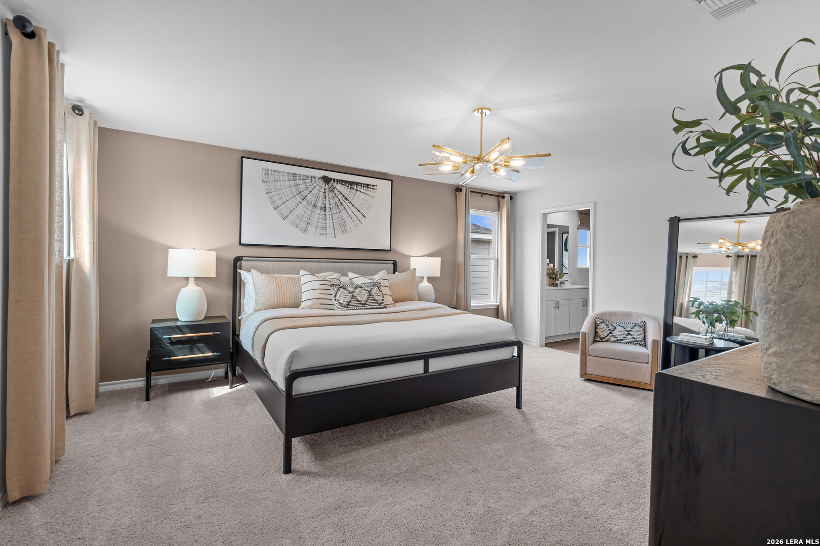 424 Raven Row Marion, TX 78124 - Photo 20 of 30 a bedroom with a large bed and a chandelier