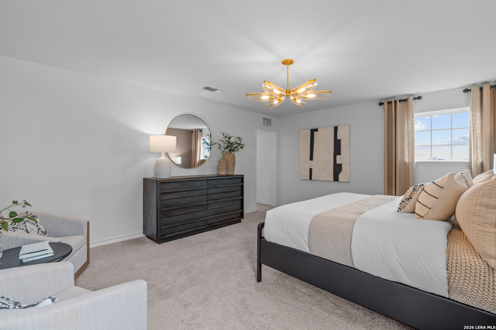 424 Raven Row Marion, TX 78124 - Photo 21 of 30 a bedroom with a bed and a chandelier