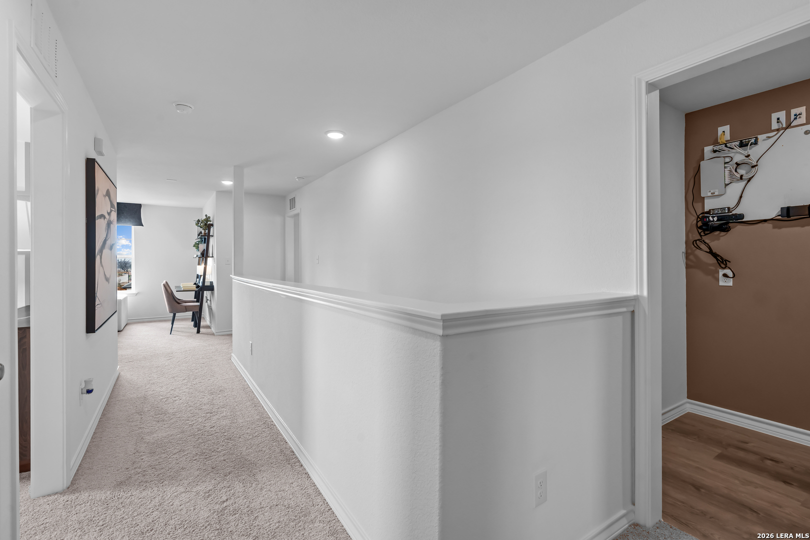 424 Raven Row Marion, TX 78124 - Photo 26 of 30 a view of a hallway with wooden floor and a living room