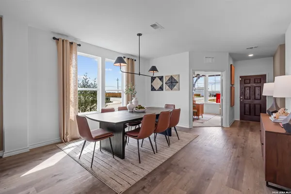 a view of a dining room with furniture window and wooden floor