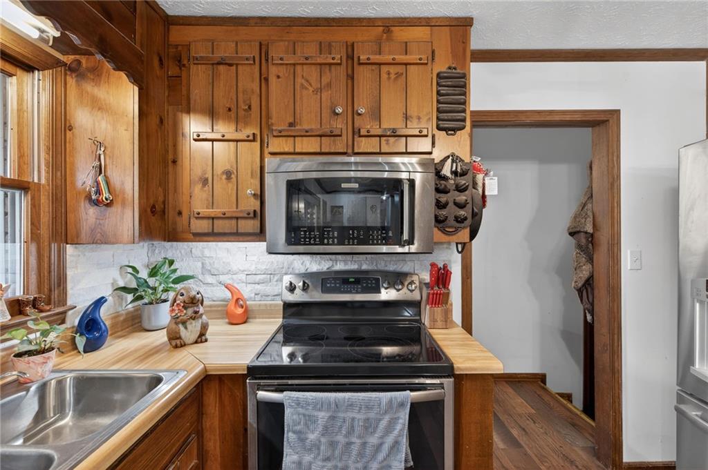 645 Davis Road Hiram, GA 30141 - Photo 11 of 30 a kitchen with stainless steel appliances granite countertop a stove and a sink