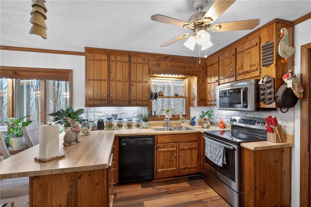 645 Davis Road Hiram, GA 30141 - Photo 13 of 30 a kitchen with a sink stove and cabinets