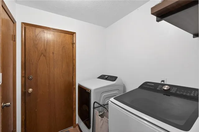 a bedroom with a bed next to a window with dresser