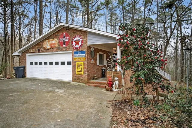 front view of a house with a yard and an trees