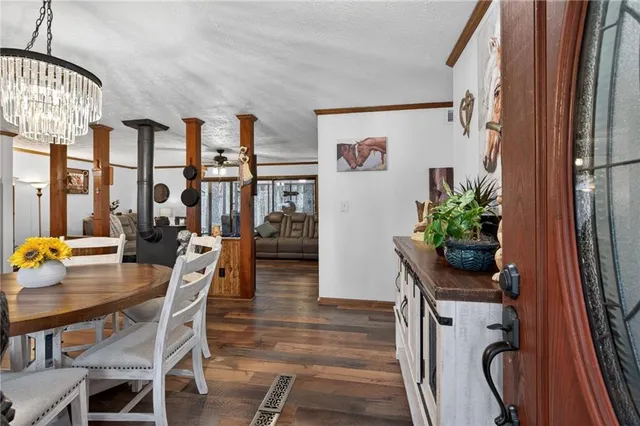 a living room with furniture a flat screen tv and a floor to ceiling window