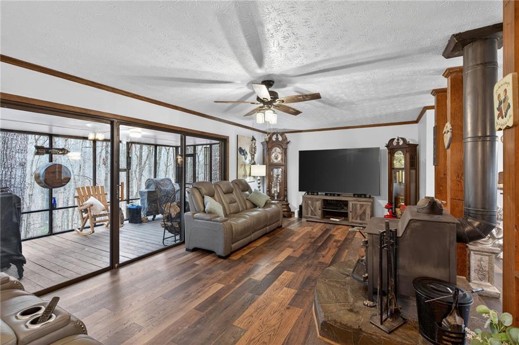 645 Davis Road Hiram, GA 30141 - Photo 7 of 30 a living room with furniture a flat screen tv and a floor to ceiling window