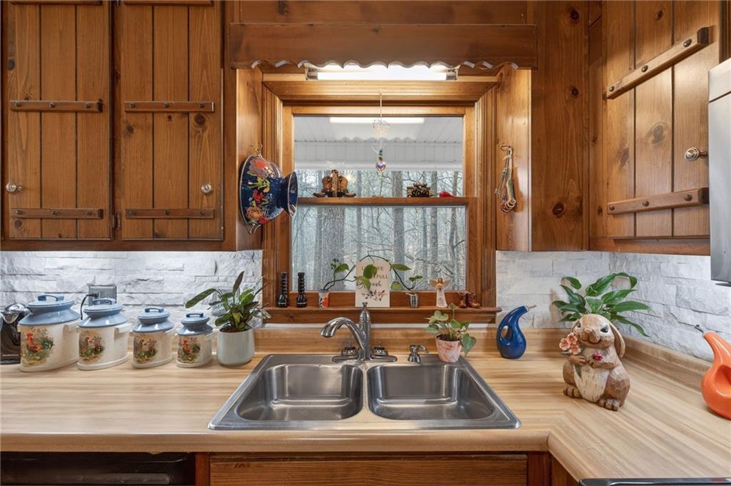 645 Davis Road Hiram, GA 30141 - Photo 10 of 30 a kitchen with a sink and a potted plant