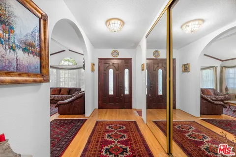 a hallway with table and couch