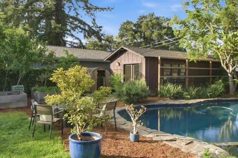 a house view with a sitting space and a lake view