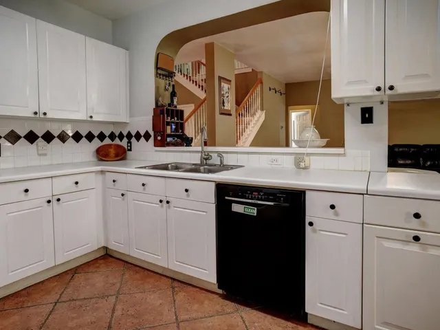 a kitchen with stainless steel appliances a refrigerator stove and sink